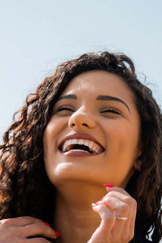 Woman laughing showing brilliant white teeth